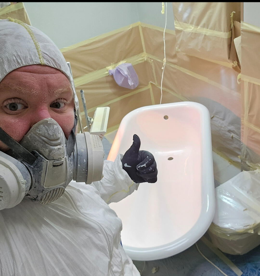 photo of glossy baths owner photo of glossy baths re-enamelling owner Seamus with a thumbs up, in ppe, in a room full of masking up and a completed bath in Reading - Berkshire